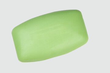 A piece of green natural soap, isolated on a white background. Body hygiene products.