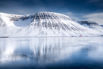 Snow-Covered Mountain Reflected in Frozen Lake