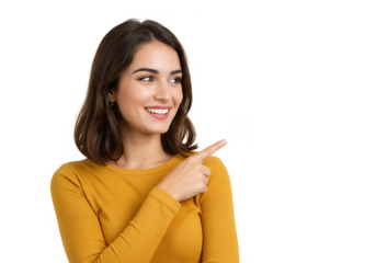 A smiling brunette woman in a yellow shirt is pointing to the right, isolated on white background