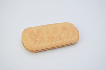 Light-tan sandwich cookie with small holes.