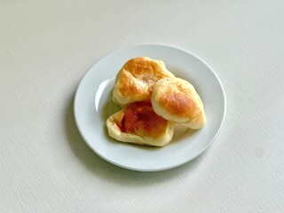 Roti Unyil — mini Indonesian sweet buns known for their soft texture and variety of fillings, a...
