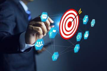 Business target concept with businessman pointing on dart board to defind and enhance marketing...