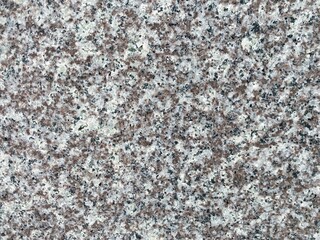 Granite stone variegated background in white-gray-brown colors.