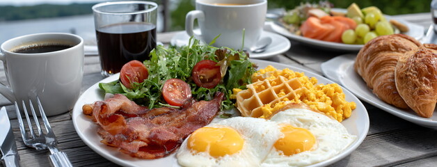 Breakfast with a view. Outdoor dining with an amazing view. Delicious meal served with a wonderful waterscape. Vacation and resort.
