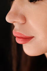 Pink-red lips after PMU with clean edges and soft texture, beauty-focused photo.