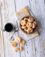 Typical brazilian sugar covered biscuit with coffee over wooden table