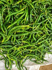 Fresh green chili peppers piled high.