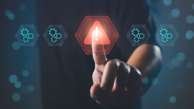 Finger pointing at alert icon among system gears, representing issue detection, problem identification, system error, troubleshooting, and technical warning in digital operations.