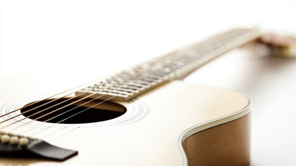 Obraz premium A single acoustic guitar isolated on white, showcasing detailed craftsmanship in a studio setting.