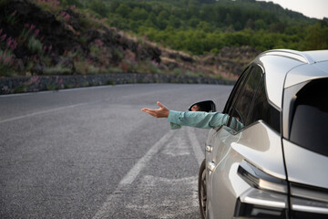 happy woman drriving a car road trip