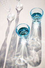 still life with vintage water and champagne glasses in the sun