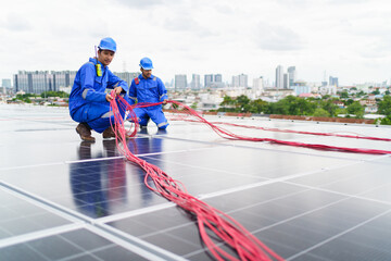 Electrical engineers are inspecting and installing a solar panels on the building rooftop.