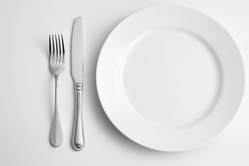 Selective focus white dish with spoon, fork and knife isolated on white background, Luxury fine dining dish with silverware on white background.