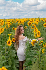 Fototapeta premium girl in white dress in sunflower field