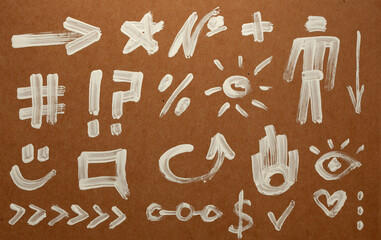 various hand drawn symbols painted on a cardboard, design elements