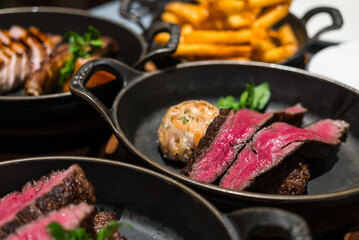 Sliced juicy steak served on cast iron