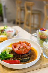 Grilled tomato served with hamburger steak plate