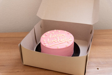 Pink house made cake with inscription message for birthday girl three years old