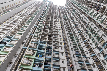 Looking up at tall apartment block from ground