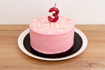 Pink house made cake with inscription message for birthday girl three years old
