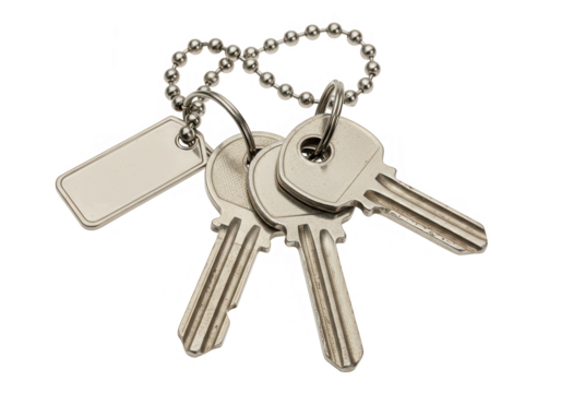 A set of three silver keys on a metal keychain with a blank tag, isolated on a white background