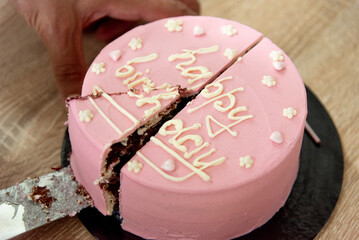 Pink house made cake with inscription message for birthday girl three years old