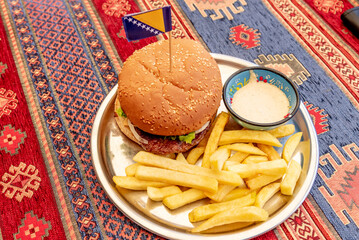 Burger dinner with meat cutlet and fries in restaurant Bosnia and Herzegovina