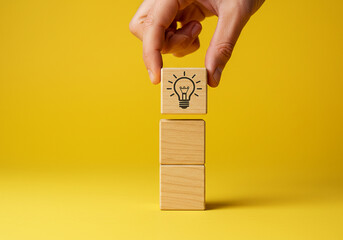 Idea generation concept with lightbulb on wooden blocks for creative thinking and innovation process