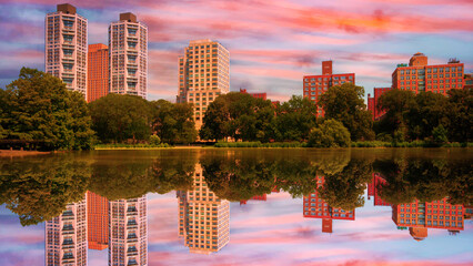 New York City skyline and Central Park landscape with building reflections over Harlem Meer Lake, capturing a tranquil sunset cloudscape in Upper Manhattan