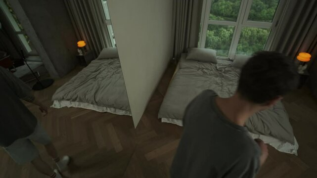 Man experiencing mental breakdown talks to himself in mirror. Psychotic episode and disturbed behavior at home.
