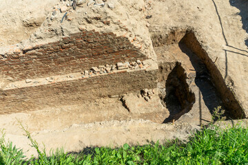 Historical Ruins Unearthed Archaeology Site. Urban Archaeological Excavation Showing Old Brick Wall...