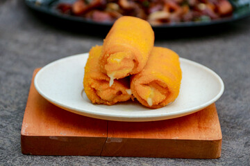 Serving Fried Cheese Rolls on Wooden Board with Appetizers