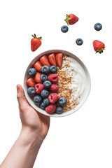 Hand holding a bowl of yogurt with berries isolated on transparent background