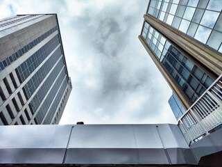 Urban architecture creates striking contrast under overcast sky in modern cityscape