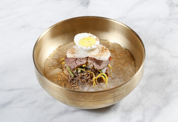 Cold Buckwheat Noodles (Korean cool noodles) decorated on thet marble table.