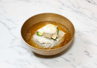Cold Buckwheat Noodles (Korean cool noodles) decorated on thet marble table.