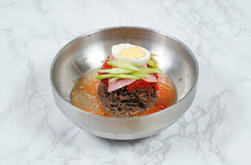 Cold Buckwheat Noodles (Korean cool noodles) decorated on thet marble table.