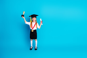 Cheerful Schoolgirl Celebrates Graduation Achievement Holding Trophy and Diploma Against Bright...