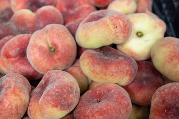 Flat-toed Chinese peach. Delicious and sweet gourmet fruit.