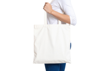 A person holds a plain white canvas tote bag with two handles, worn over the shoulder, showing a minimalist style and casual use.
