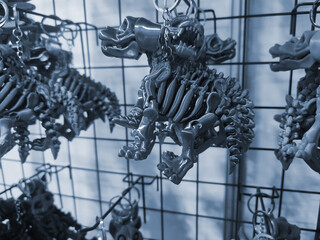 Objects keychains in form of dog skeleton models of toys printed on 3D printer from molten plastic...