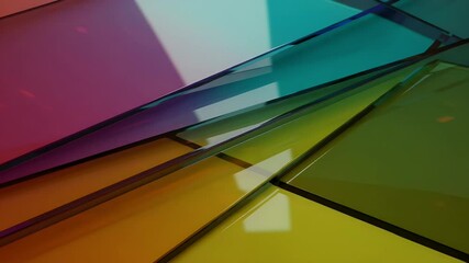 Colorful translucent glass sheets layered together, casting vibrant reflections in a bright setting