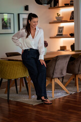 Portrait of an attractive woman standing in her modern home