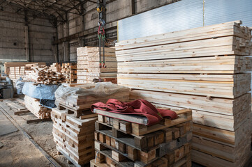 Stacked wooden planks close-up at lumber warehouse. Wood industry concept