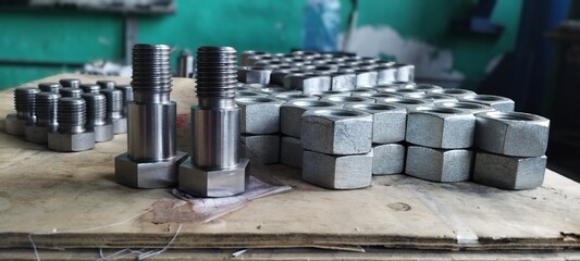 Close-up of new metal bolts and nuts. Steel bolts and nuts. Industrial fasteners displayed on a...