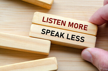 Listen more and speak less phrase on wooden blocks, a reminder to practice thoughtful listening...