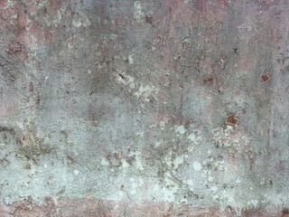 Mottled Concrete Wall with Green and Brown Patches
