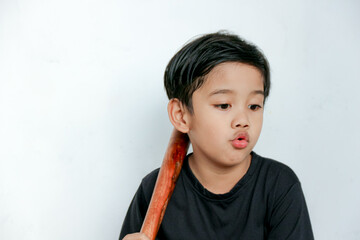 Boy Holding Wooden Stick Making Funny Face Against White Background