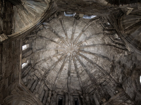 Majestic stone ribbed vault ceiling reaching towards the sky in ancient building