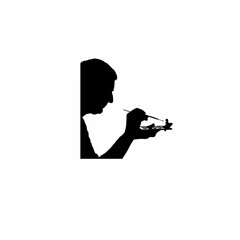 Fototapeta premium Silhouette of man painting miniature model on white background
